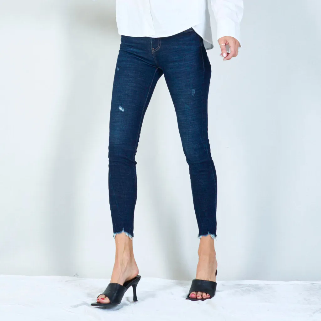 Distressed skinny jeans with raw hem wholesale