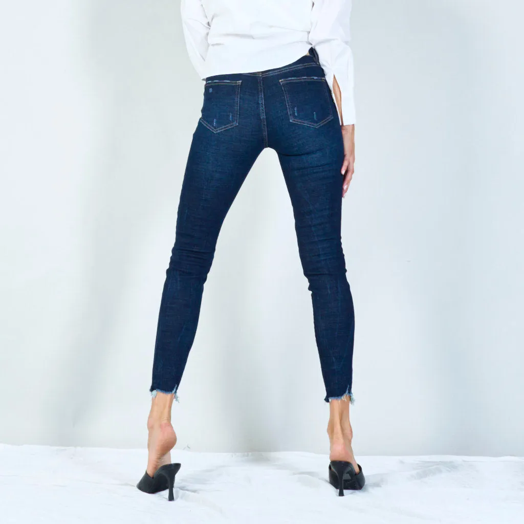 Distressed skinny jeans with raw hem wholesale