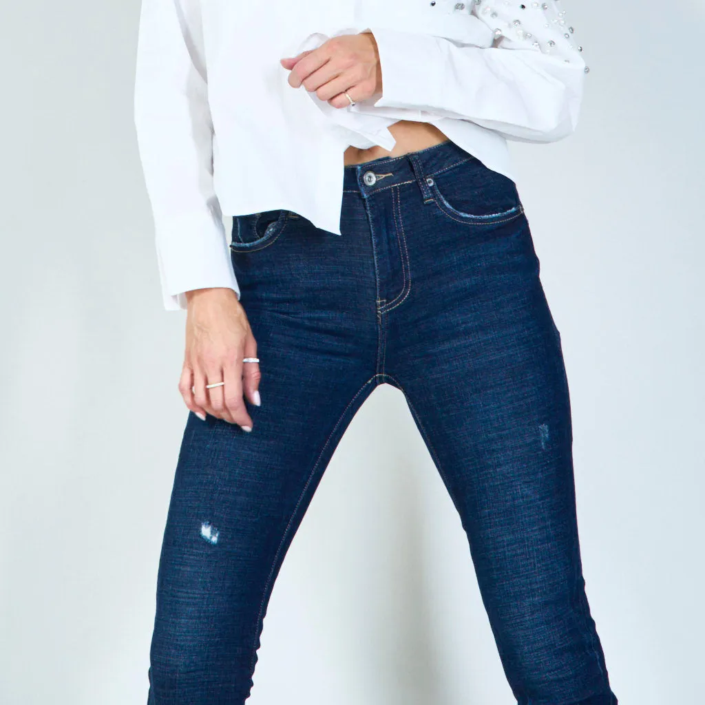 Distressed skinny jeans with raw hem wholesale